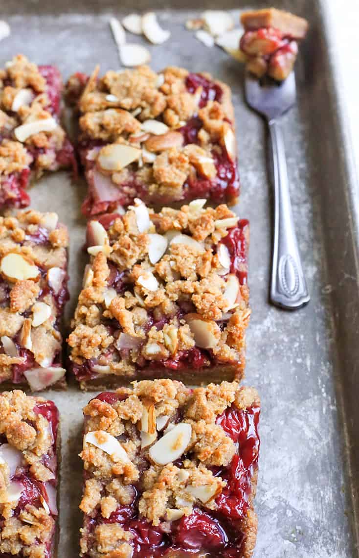 These Paleo Cherry Pie Crumb Bars are so simple and delicious! A thick shortbread crust, fresh fruit filling and irresistible crumb topping. These layered bars are vegan, gluten free, dairy free, and naturally sweetened.